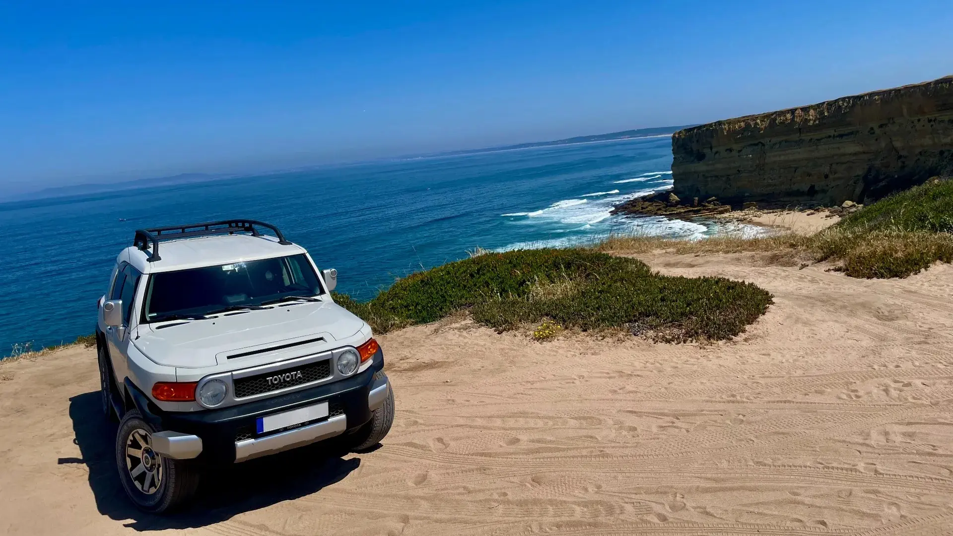 Toyota FJ Cruiser on Atlantic cliffs with travelers
